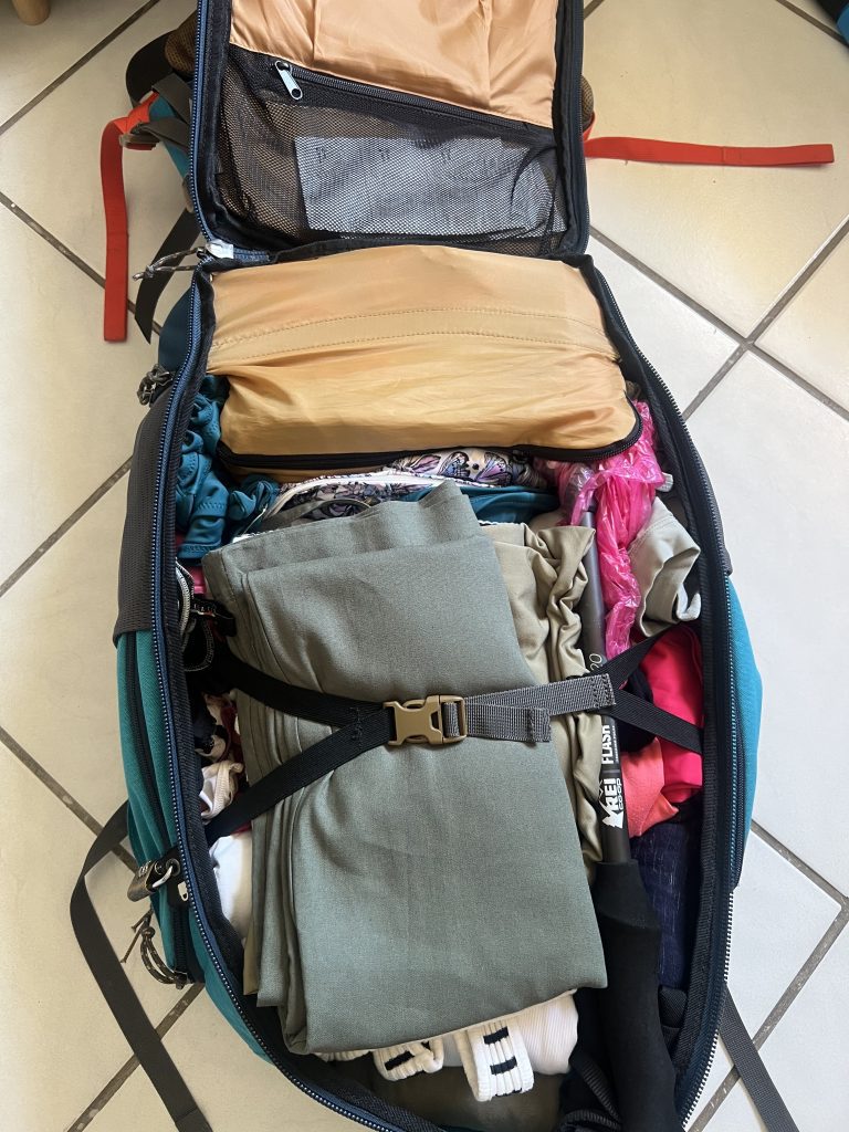 Clothes packed neatly in a backpack