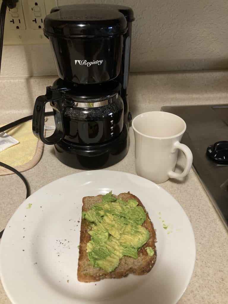 Quick homemade breakfast of coffee and avocado toast in my hotel room