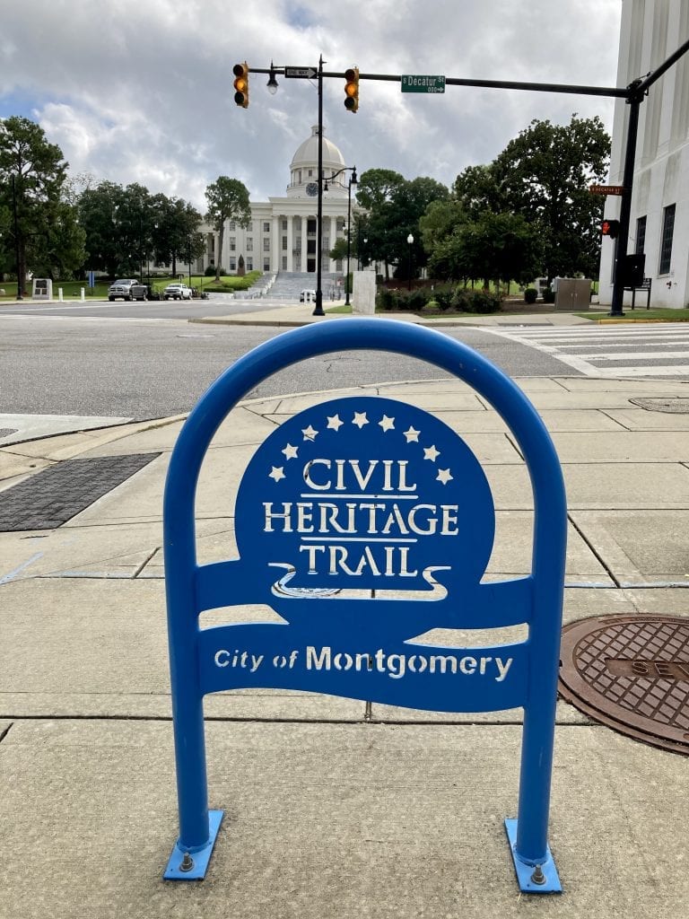 Civil rights heritage trail sign with Alabama State Capitol in the background