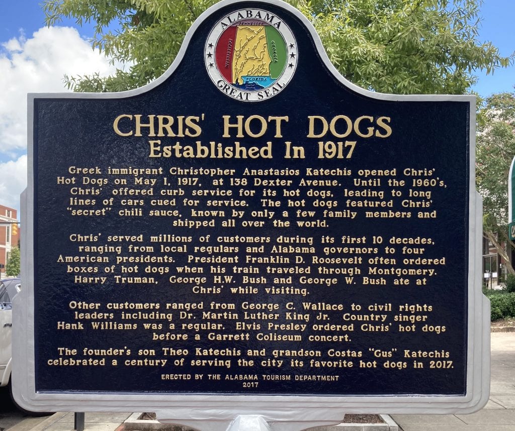 Sign telling the story of Chris' hot dogs and the Greek immigrants who arrived in the US and set it up in 1917