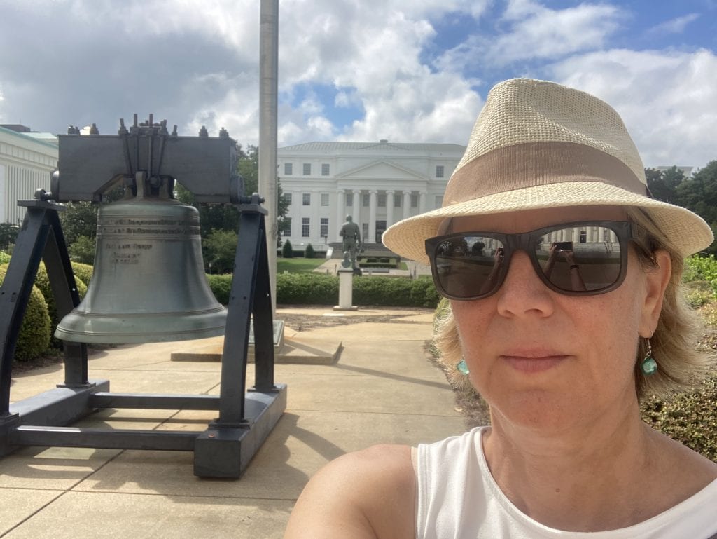Photo of author at the State Capitol bell in Montgomery, Alabama