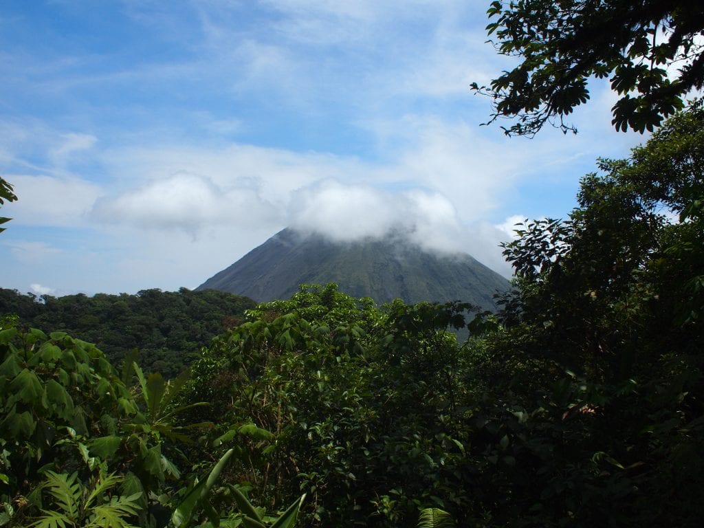 Arenal volcano's cone hidden by clouds in Fortuna, Costa Rica