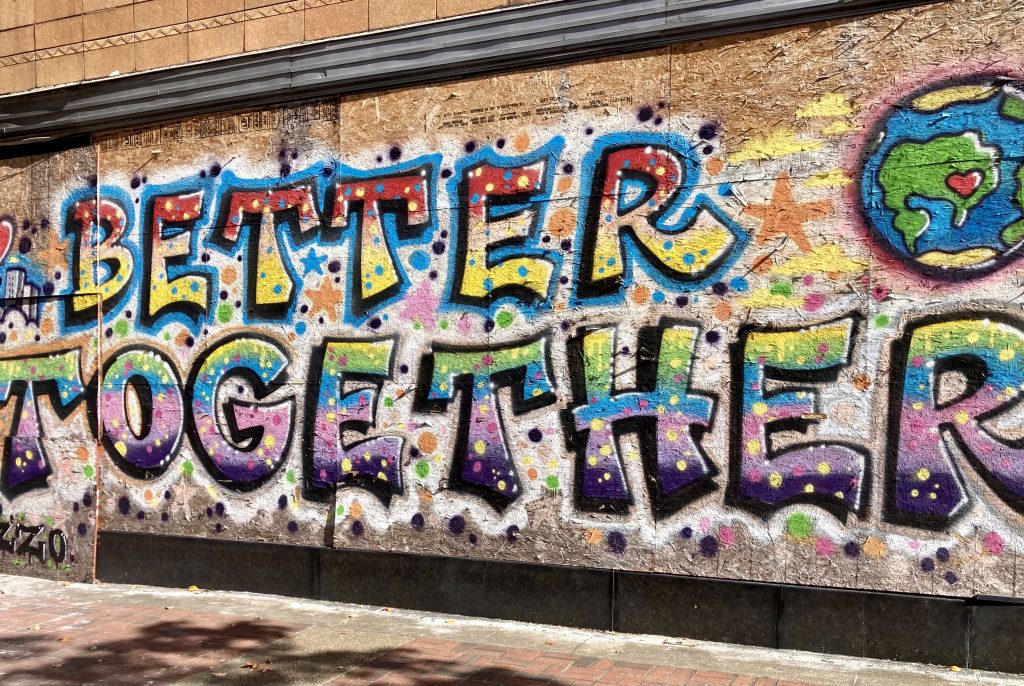 Multicoloured graffiti which reads "Better Together"